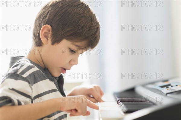 Hispanic boy practicing piano