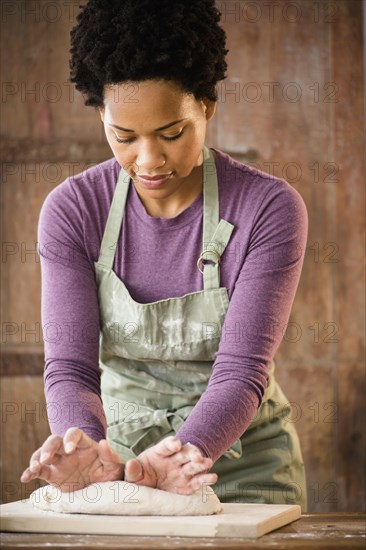 Black woman kneading dough