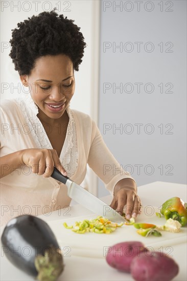 Black woman slicing vegetables