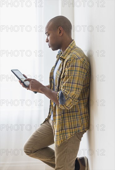 Black man using digital tablet
