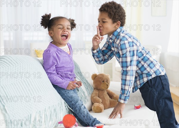 Black children playing on sofa