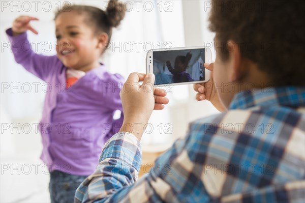 Black children playing with cell phone