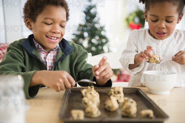 Black children baking cookies together