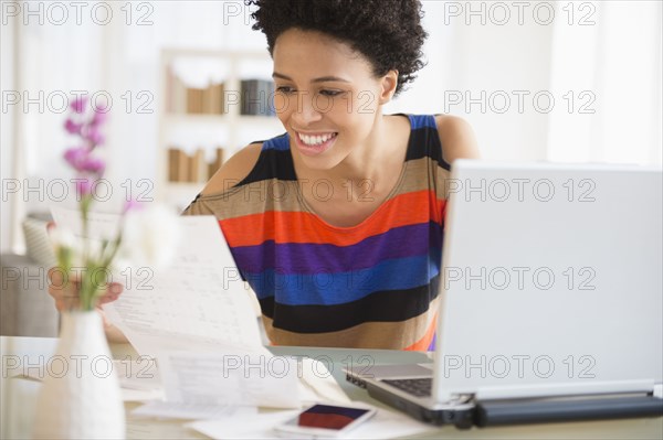 Black woman paying bills online