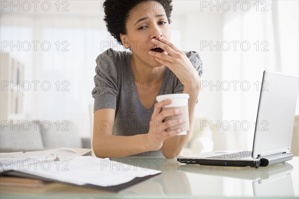 Black woman yawning at desk