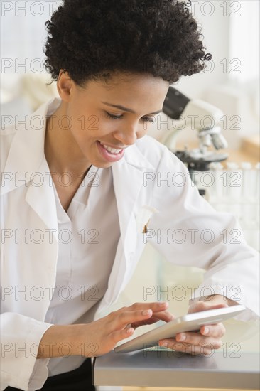 Black scientist using digital tablet in lab