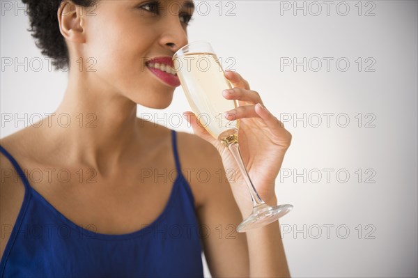 Black woman drinking champagne