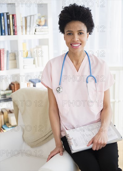 Black nurse smiling at home visit