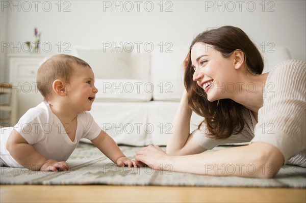 Mother and baby playing in living room