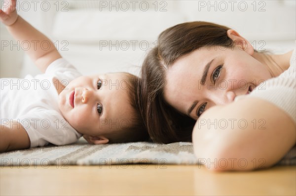 Mother and baby playing in living room