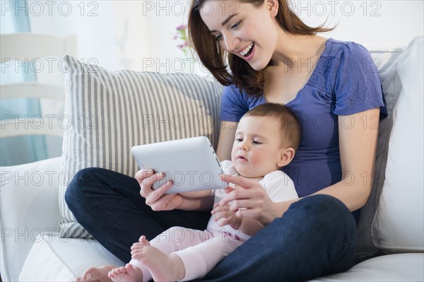 Mother and baby using digital tablet