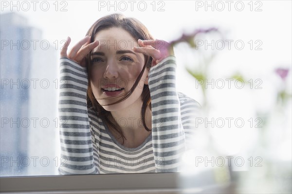 Woman peering in through window