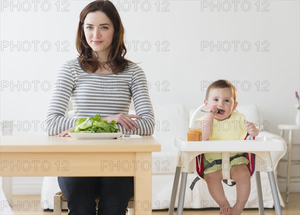 Mother and baby eating together