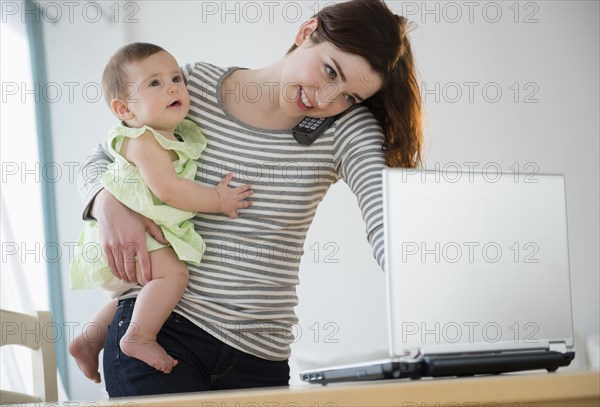 Mother multitasking with baby