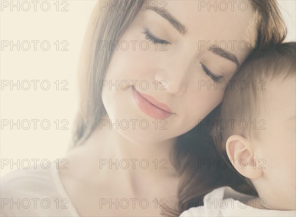 Smiling mother cradling baby