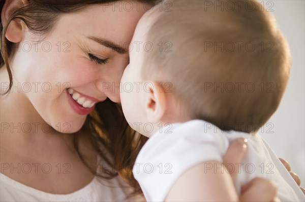 Smiling mother cradling baby