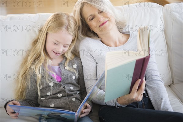 Senior Caucasian woman and granddaughter reading together