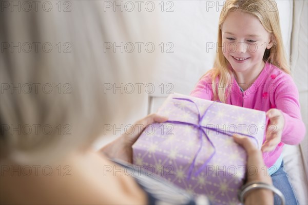 Senior Caucasian woman giving granddaughter present