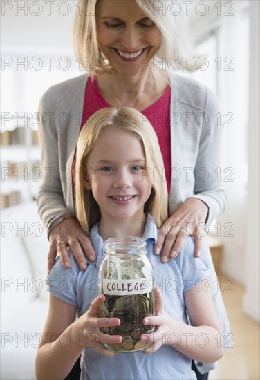 Senior Caucasian woman and granddaughter saving for college