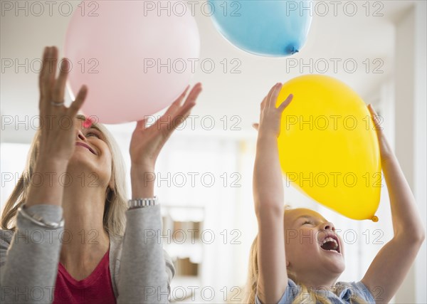 Senior Caucasian woman and granddaughter playing with balloons