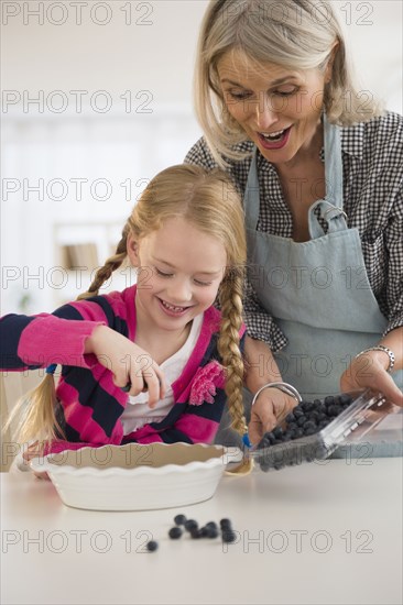 Senior Caucasian woman and granddaughter baking together