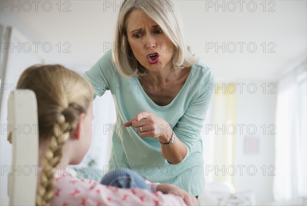 Senior Caucasian woman scolding granddaughter