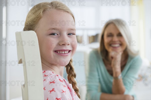 Caucasian girl smiling in chair