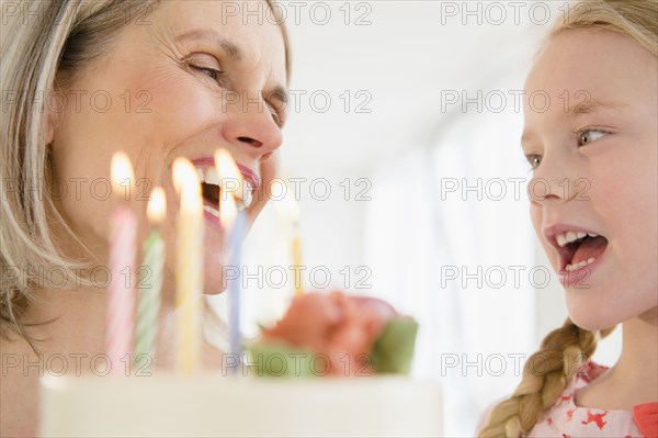 Senior Caucasian woman and granddaughter celebrating birthday