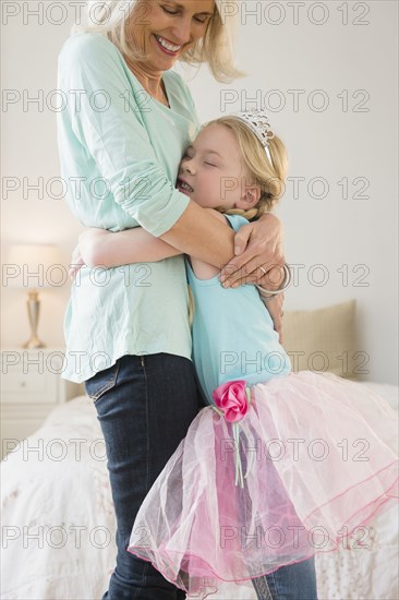 Senior Caucasian woman and granddaughter hugging