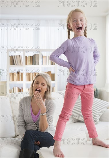 Tired Senior Caucasian woman playing with granddaughter