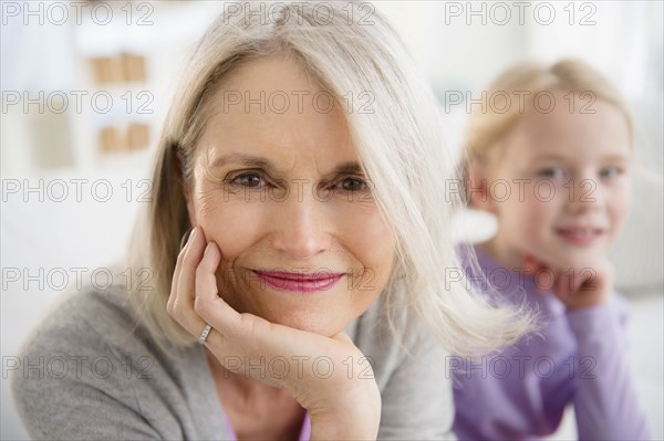 Senior Caucasian woman sitting with granddaughter