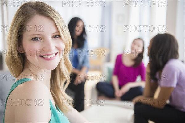 Smiling woman sitting with friends