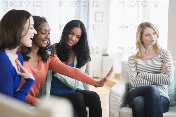 Jealous woman ignoring friend's engagement ring