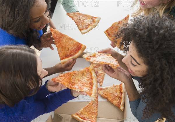 Women eating pizza together