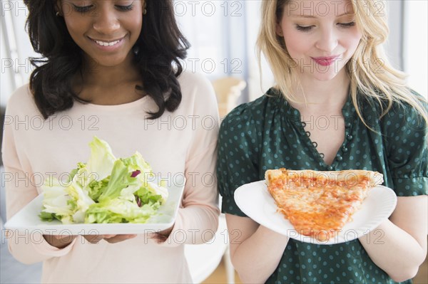 Women eating pizza and salad