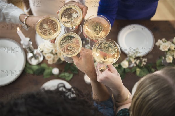 Women toasting each other with champagne