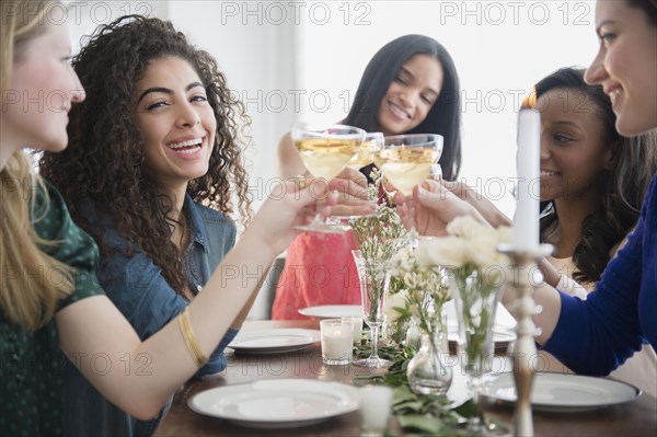 Women toasting each other with champagne