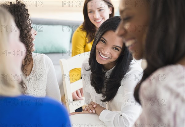 Women relaxing together in living room