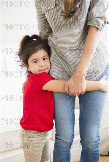 Hispanic girl hugging mother