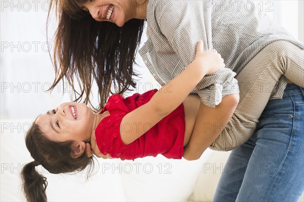 Hispanic mother and daughter playing together