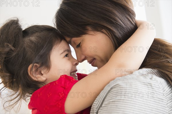 Hispanic mother and daughter hugging