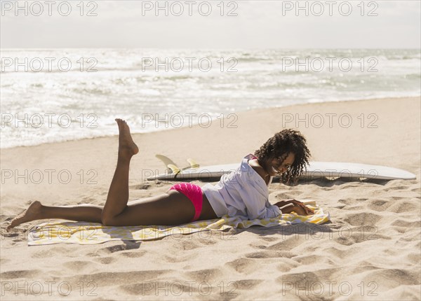 African American woman relaxing on beach