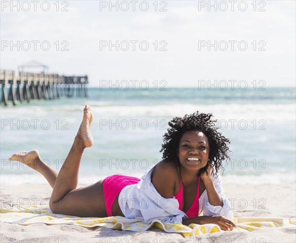 African American woman relaxing on beach