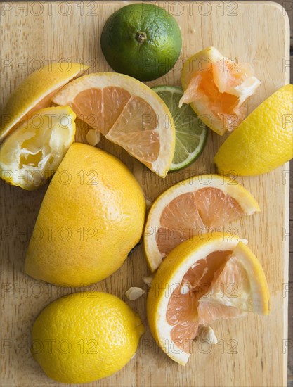 Sliced and squeezed fruit on wooden board