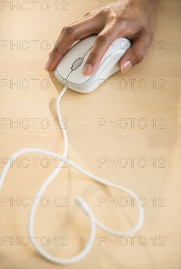 Mixed race woman using computer mouse
