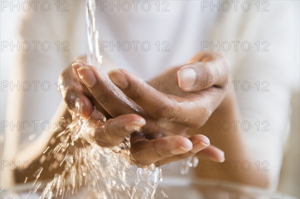 Mixed race woman washing her hands
