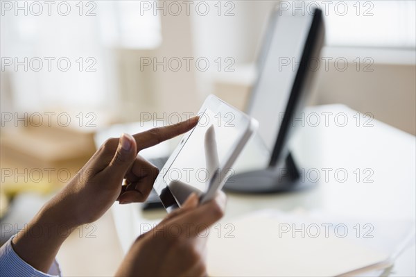 Mixed race businesswoman working on digital tablet