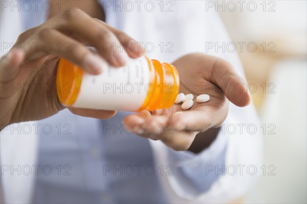 Mixed race doctor taking medication