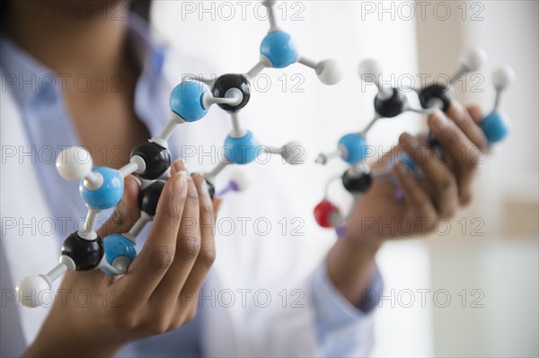 Mixed race scientist examining molecular model