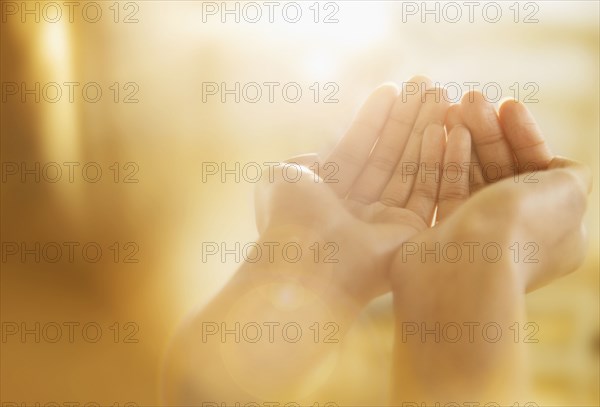 Mixed race woman holding out cupped hands